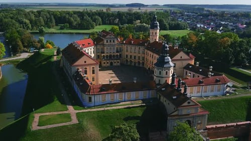 Fly in the morning over Nesvizh Palace in Minsk. Panoramic view of a castle and park. Drone shot of