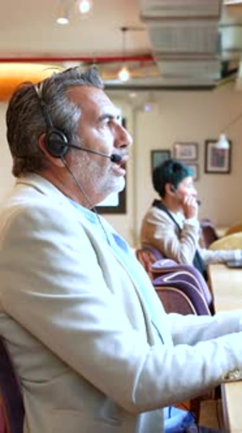 Call Center Agent Talking on Headset in Office Environment