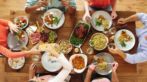 Overhead view of friends eating meal together at home