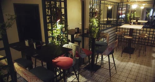 Beautiful slow motion shot of a beautiful area of an elegant restaurant with high tables, artificial