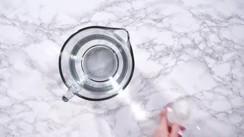 Clear Pitcher with Water on Marble Countertop