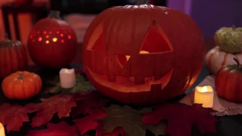 Tilt of Spooky decoration for halloween with carved pumpkins and candles. October decorations.