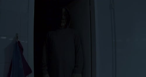 Masked Figure in Dark Doorway