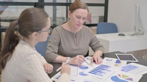 Rear View of Female Entrepreneurs Doing Paperwork