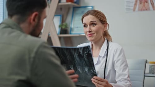 Doctor Discusses X-Ray Results With Patient