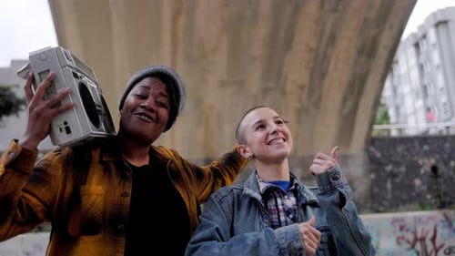 Two Young Adults Dancing with a Boombox in the City