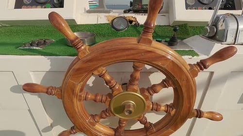 Steering Wheel and Navigation Compass on a Yacht Background of Red Sea. The Concept of Vacation or T