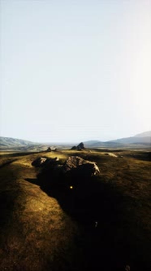 Grassy Field With Distant Hill