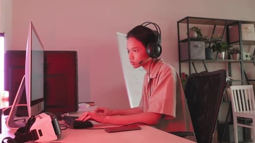 Asian Teenager Gaming on Computer