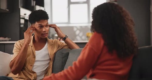 Couple Discussing on Sofa at Home