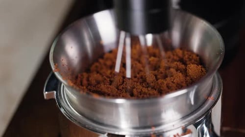 Mixing Ground Coffee in a Metal Bowl