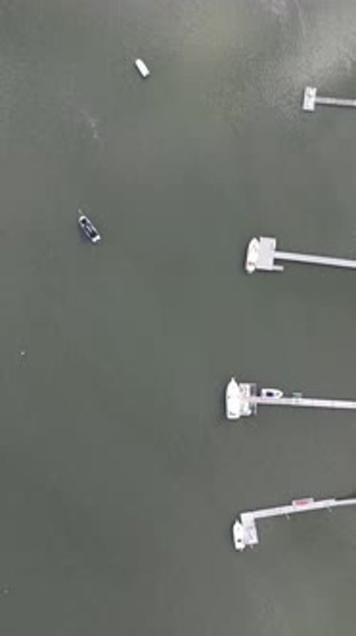 Stunning top down aerial perspective flying over a large harbor, revealing numerous expensive