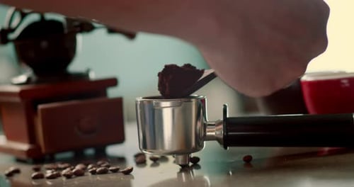 Man Pouring Ground Coffee View Hand From a Wooden Spoon Pours Ground Coffee Into a Coffee Brewing
