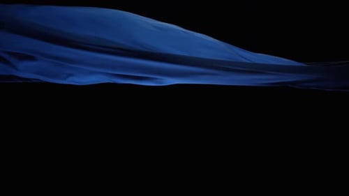 Blue Silk Cloth Flying In Black Background - studio shot