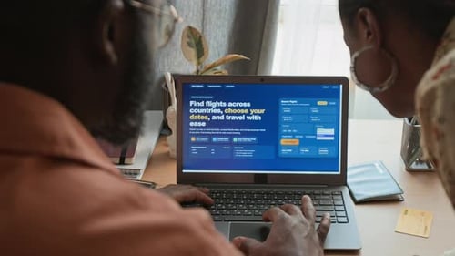Black Couple Choosing Destination and Travel Dates on Flight Booking Website