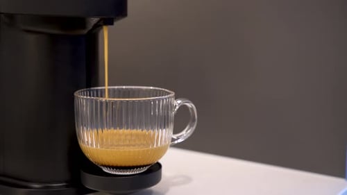 Pouring Espresso into Glass Cup from Coffee Machine