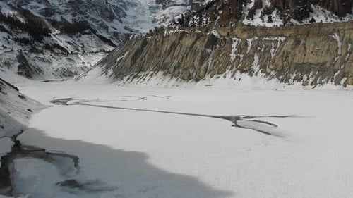 Aerial Pan Shot of melting Gangapurna glacial lake below Annapurna in Manang, Nepal