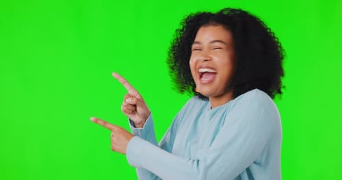 Happy woman, pointing finger and green screen for advertising, announcement or promotion