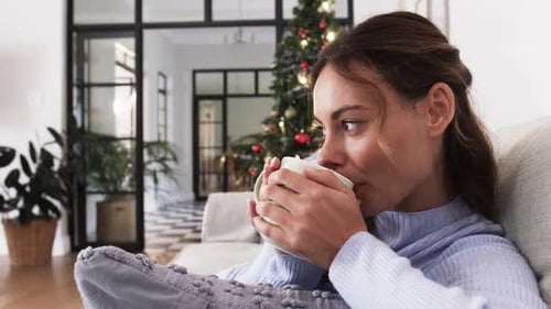 Woman Relaxing With Coffee At Christmas Time