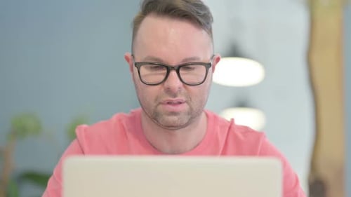 Close Up of Man having Headache while Working on Laptop