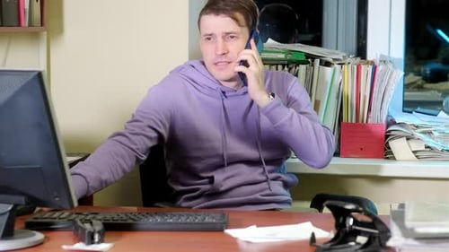 Young Man in Office at Night