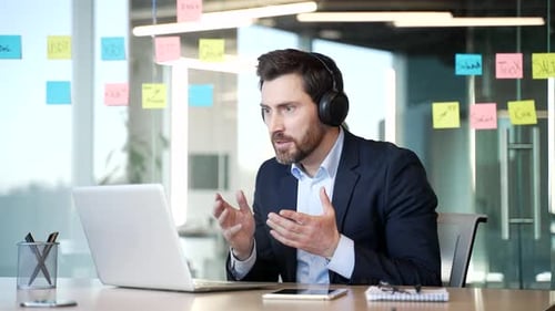 Excited Man Celebrating Success at Office Desk