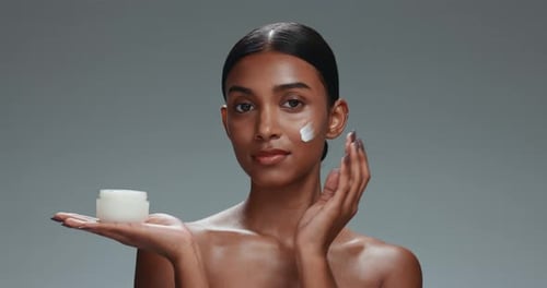 Skincare, face cream and woman in studio for health, wellness and natural routine