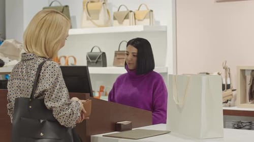 Elegant Woman Buying Clothes at Designer Showroom