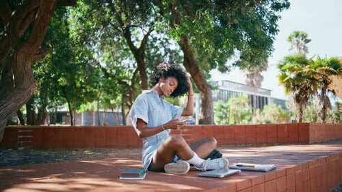 Trendy Girl Making Selfie on Smartphone Sitting Ground Under Street Trees