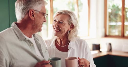 Senior Couple Laughing Together in Sunny Kitchen