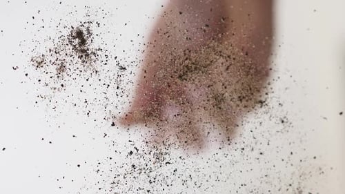 Dirt and Sand Falling on White Surface