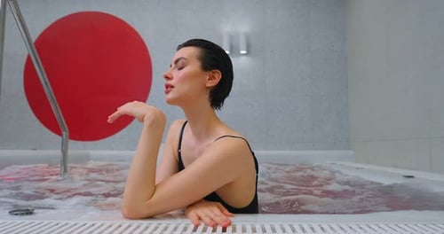 Pretty Brunette Woman Enjoying SPA Relaxing In Jacuzzi Relax And Pleasure In SPA Center Portrait