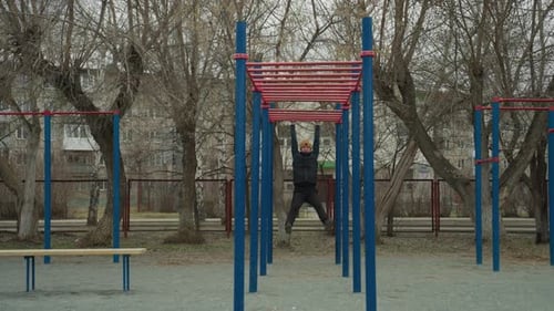 Coach Swinging on Iron Bar in Urban Park with Residential Background