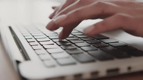 Close Up of Hands Typing on Laptop Keyboard