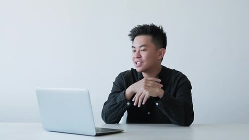 Young Adult on Laptop Video Call Indoors