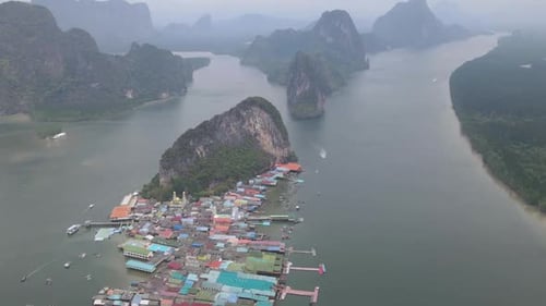 Time lapse and aerial view fly over Panyee island and village in Phang-nga of Thailand