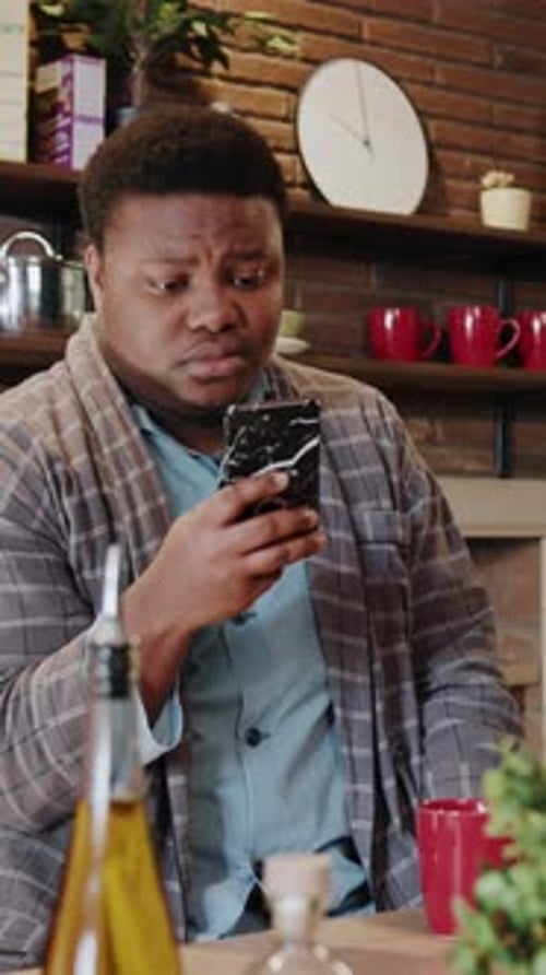 Casual Morning Routine A Man Checking His Phone While Relaxing at Home in Comfort