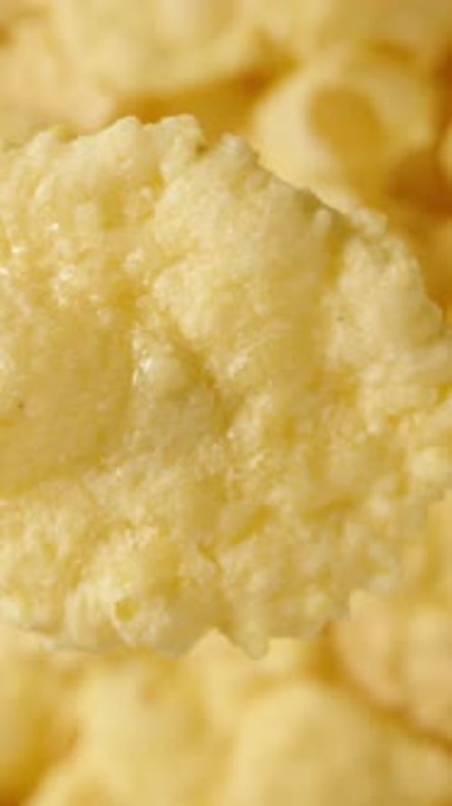 Vertical video.Corn flakes for breakfast, viewed from a top-down perspective in a close-up