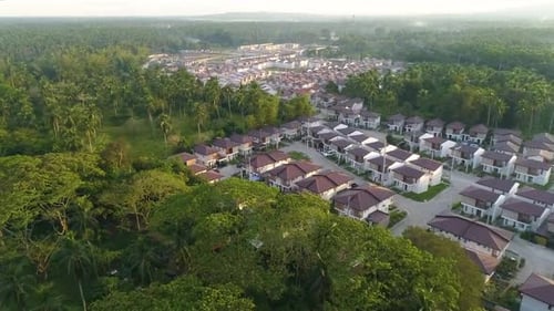 Aerial Shot Of A Newly Built Village In Asia Surrounded By Trees