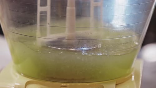 Green Liquid Being Mixed