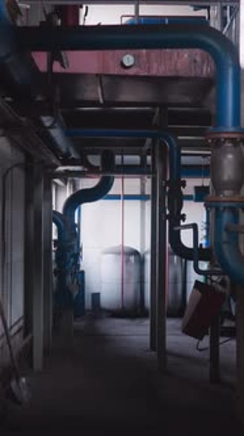 Empty Aisle with Gas Pipes and Large Tanks in Boiler House