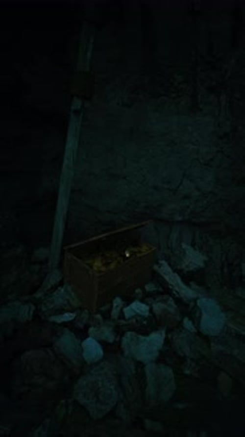 Hidden Treasure Chest Waits in Dark Cave Surrounded By Rocky Debris