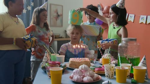 Kids Celebrate Birthday with Cake and Gifts