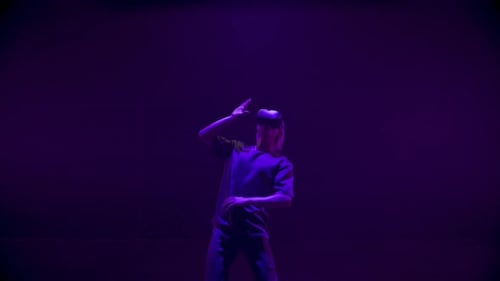 Man Using Virtual Reality Headset in Dark Room
