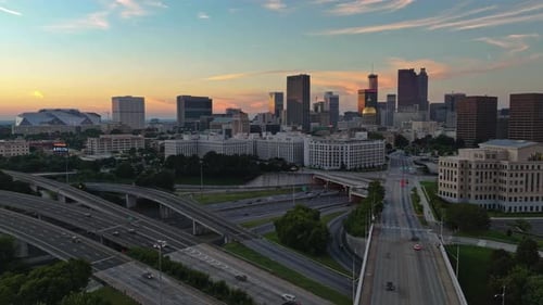 Hyperlapse drone shot of high-frequented highway and lighting Modern Skyline of Atlanta City in back
