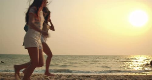 Women friends running enjoy life playing and freedom beach at sunset, Attractive together