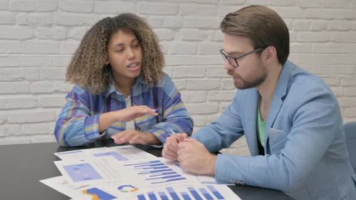 Young Teammates Working on Documents in Office