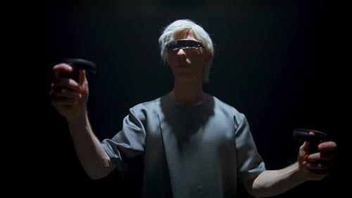 Man Using Virtual Reality Headset and Controllers