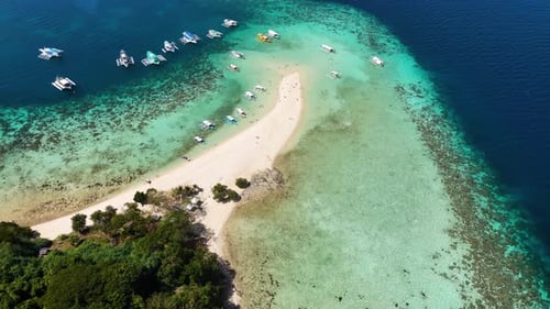Stunning drone shot of Bulog Dos Island, with its clear blue waters and tropical island beauty.
