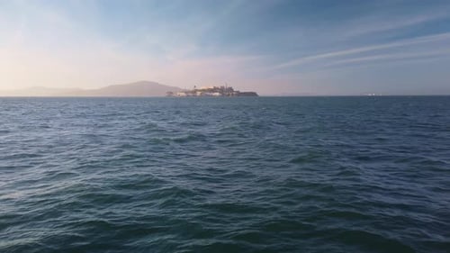 Gimbal wide static shot of Alcatraz Island from the San Francisco shoreline in California. 4K